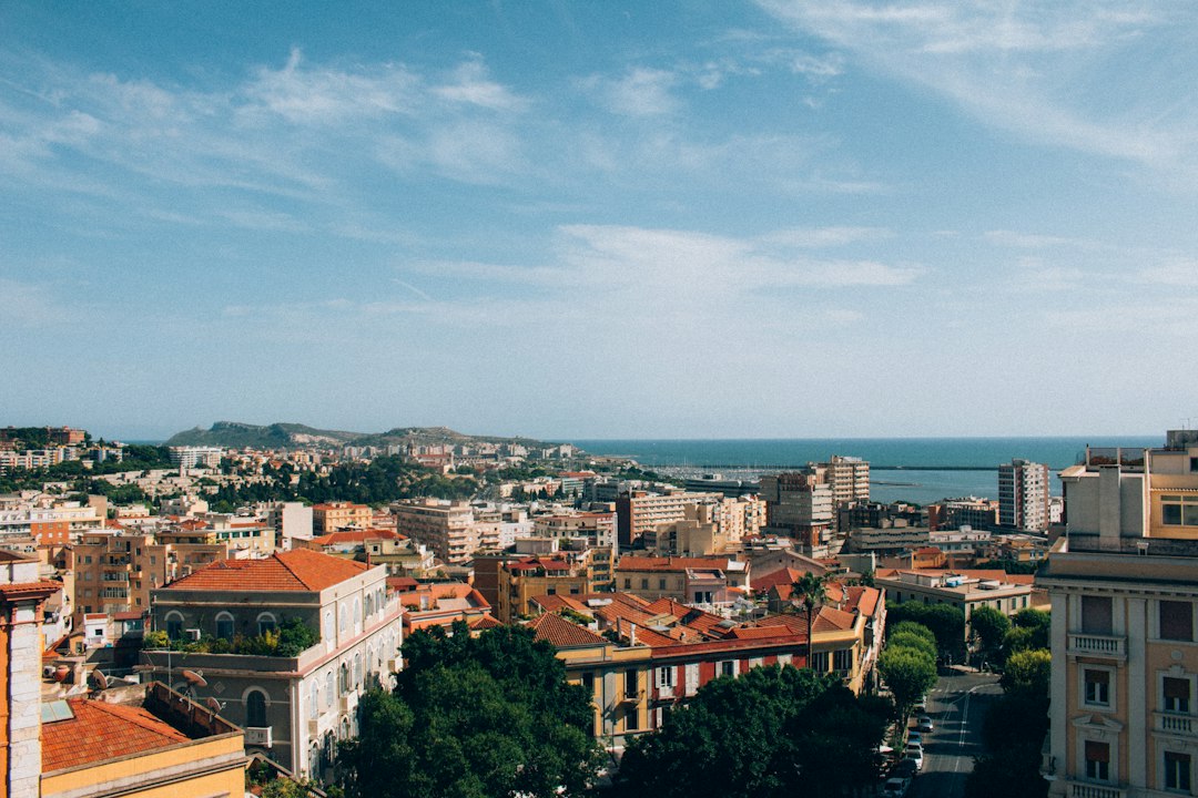 Vista panoramica del porto di Cagliari al tramonto con computer portatili su una terrazza